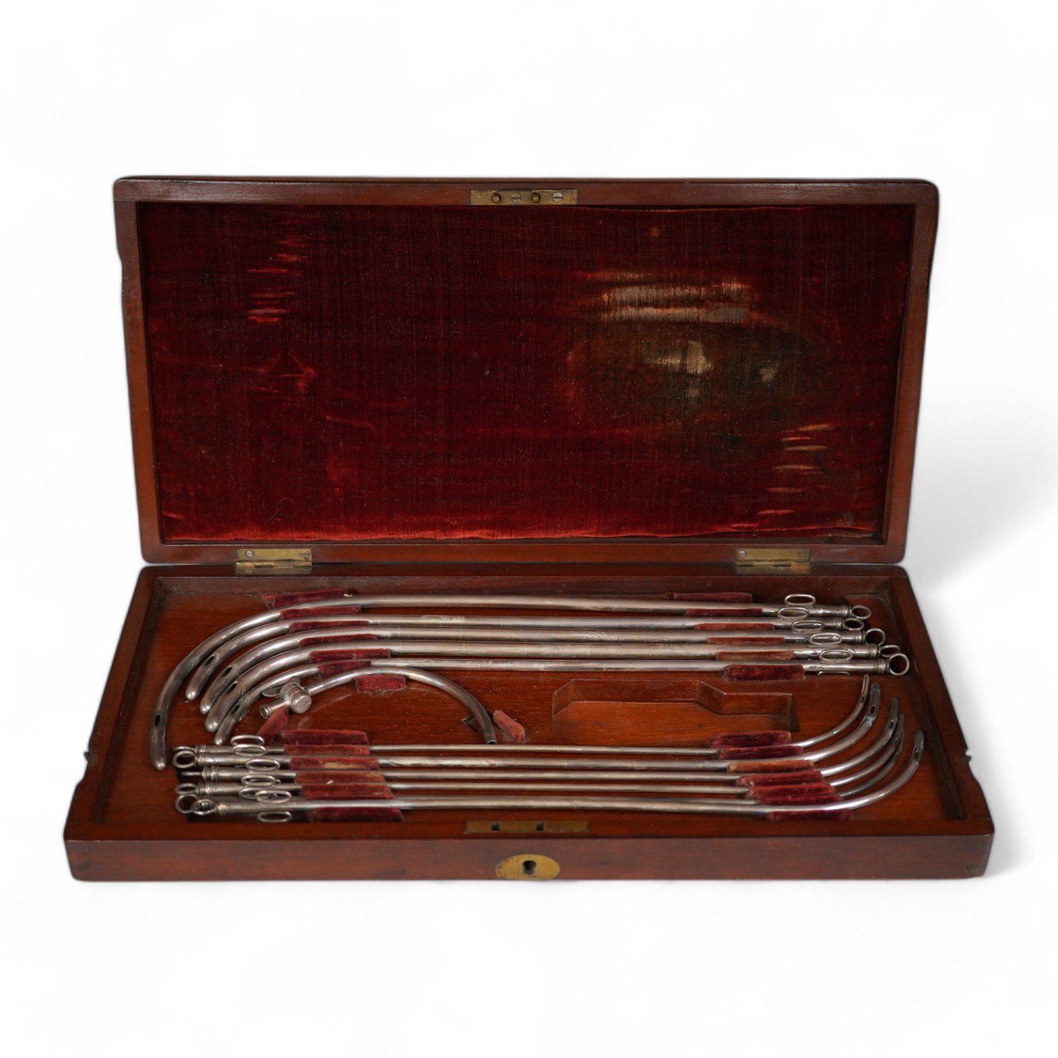 A mid 19th century mahogany cased medical set of catheter surgical instruments, inset plate to the lid engraved with ‘Wimbledon 1865. T. Wright, RHR’, 33cm wide. Condition - fair to good.